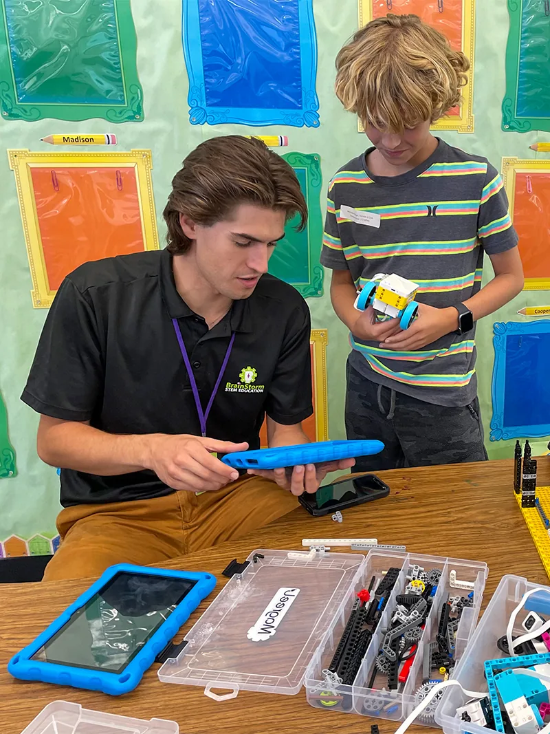 A BrainStorm STEM educator working with students.