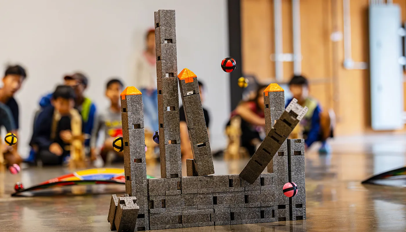 Students testing an engineering structure during a BrainStorm hands-on activity.