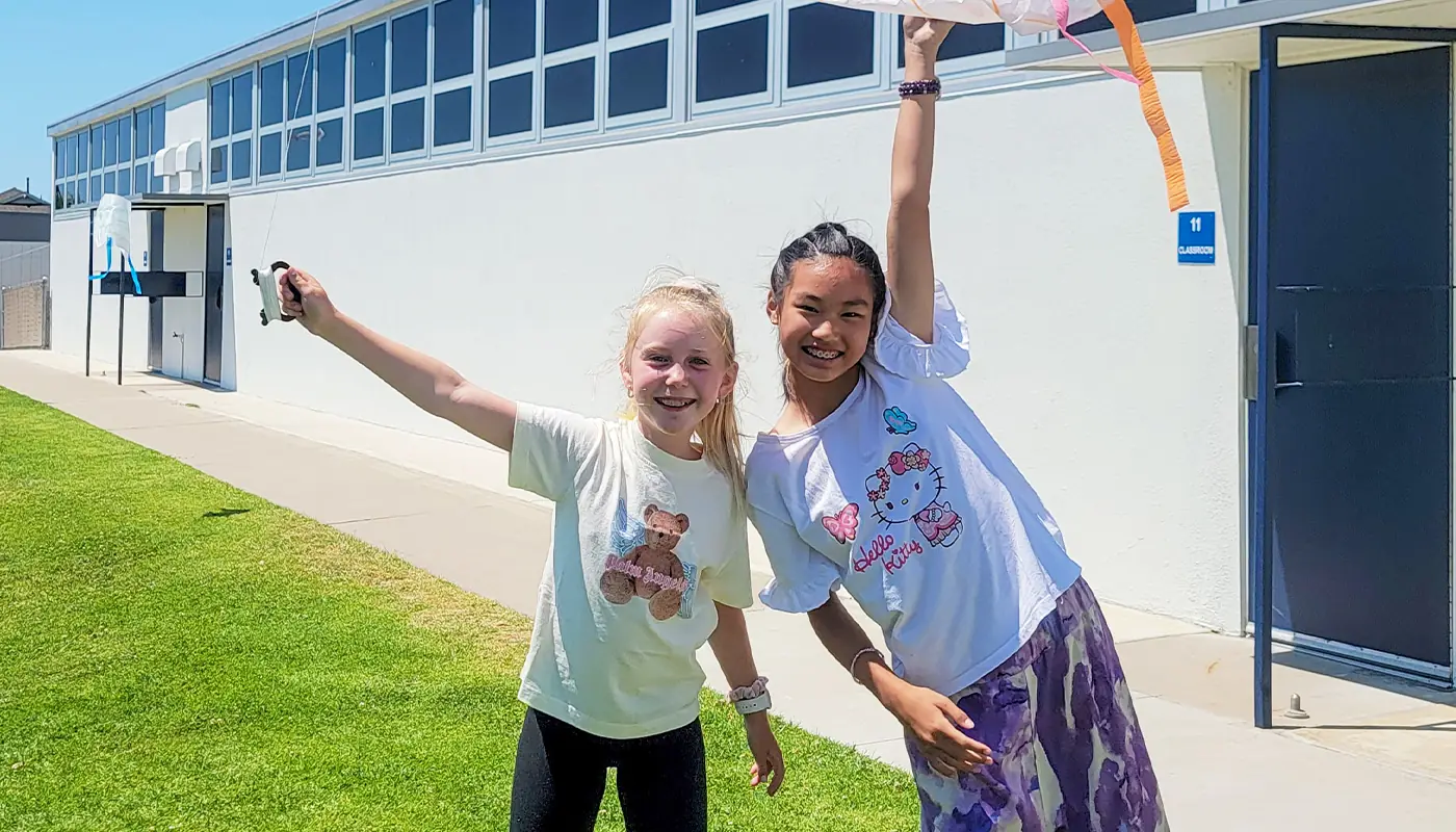 Students celebrating during an outdoor STEM activity.