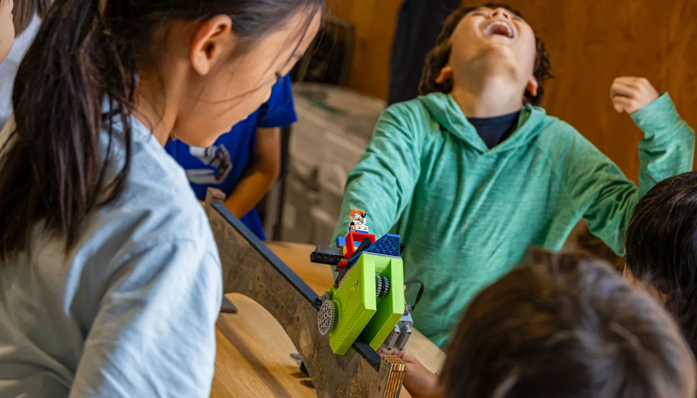 Students reacting to a hands-on engineering demonstration during a BrainStorm program.