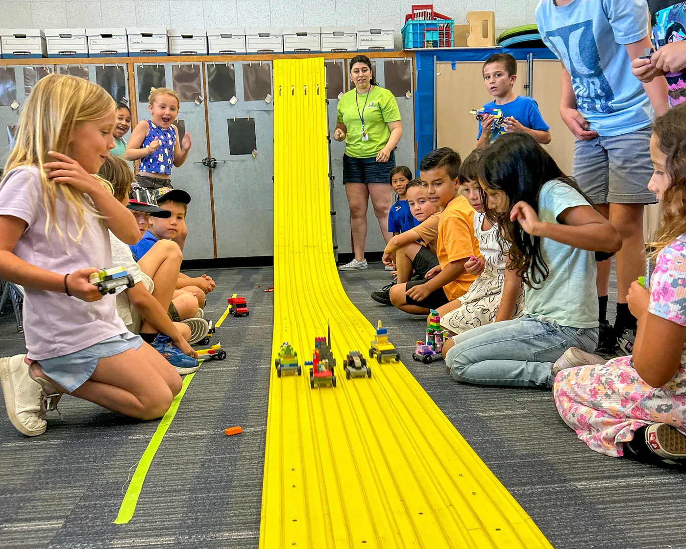 Kids building hands-on STEM projects together in a BrainStorm after-school class.