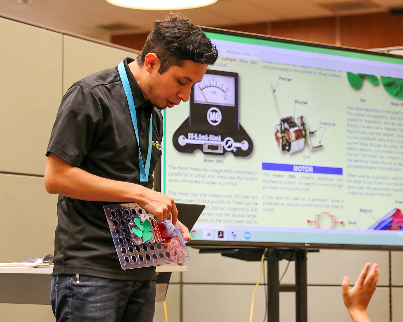 A BrainStorm instructor leading a hands-on STEM lesson in a school classroom.