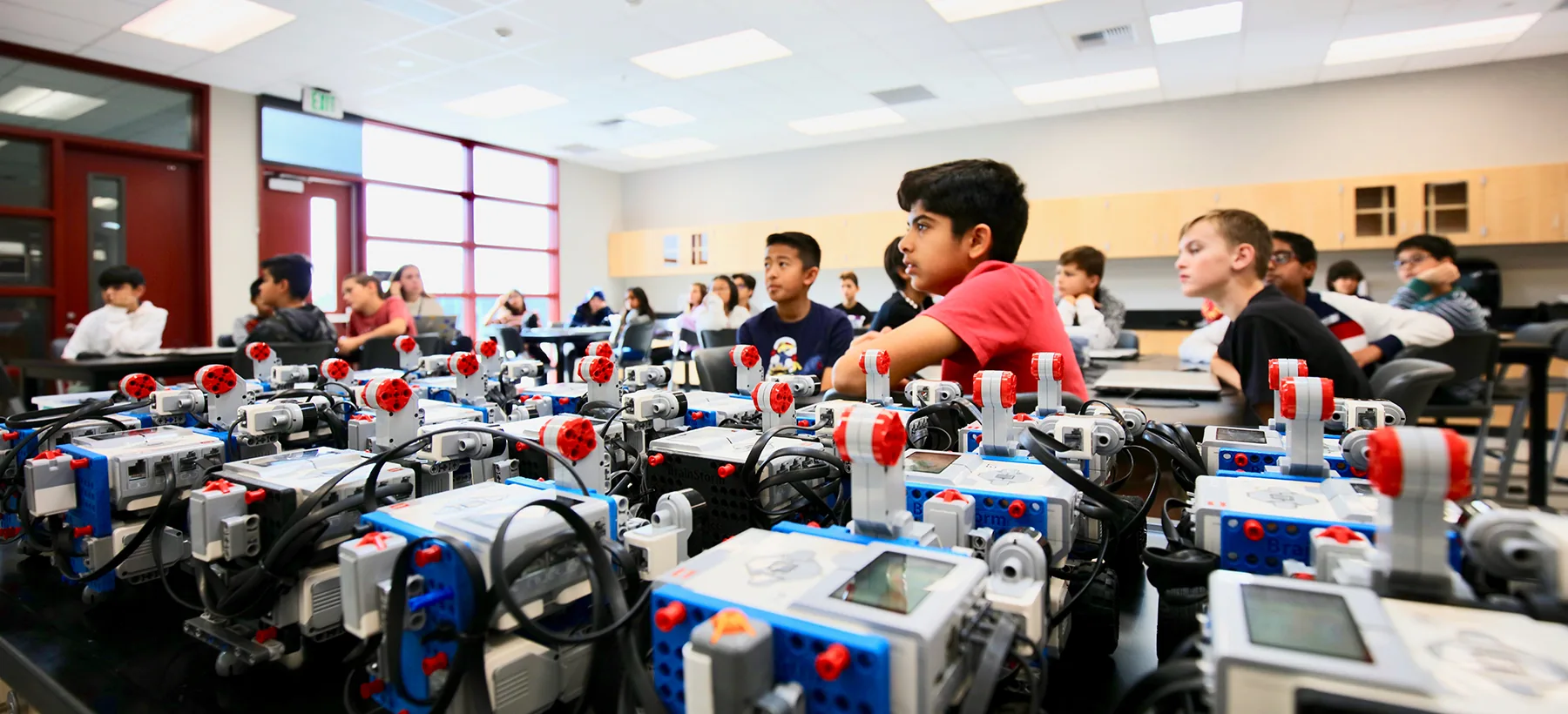 A BrainStorm instructor leading a hands-on STEM lesson in a school classroom.